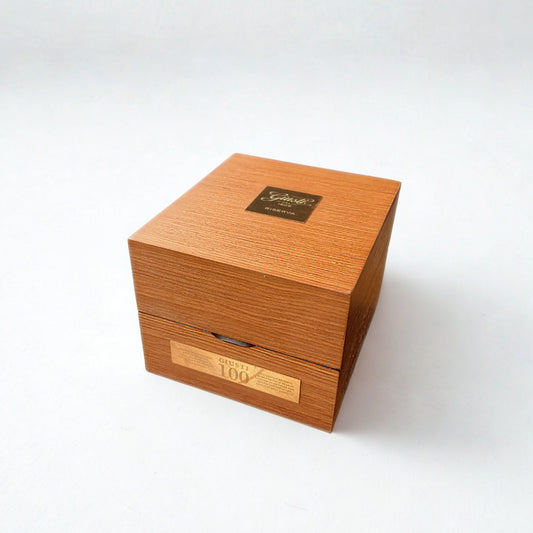 Wooden box with gold accents on a white background