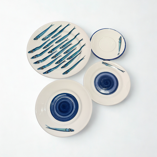Set of ceramic plates with fish design on a white background