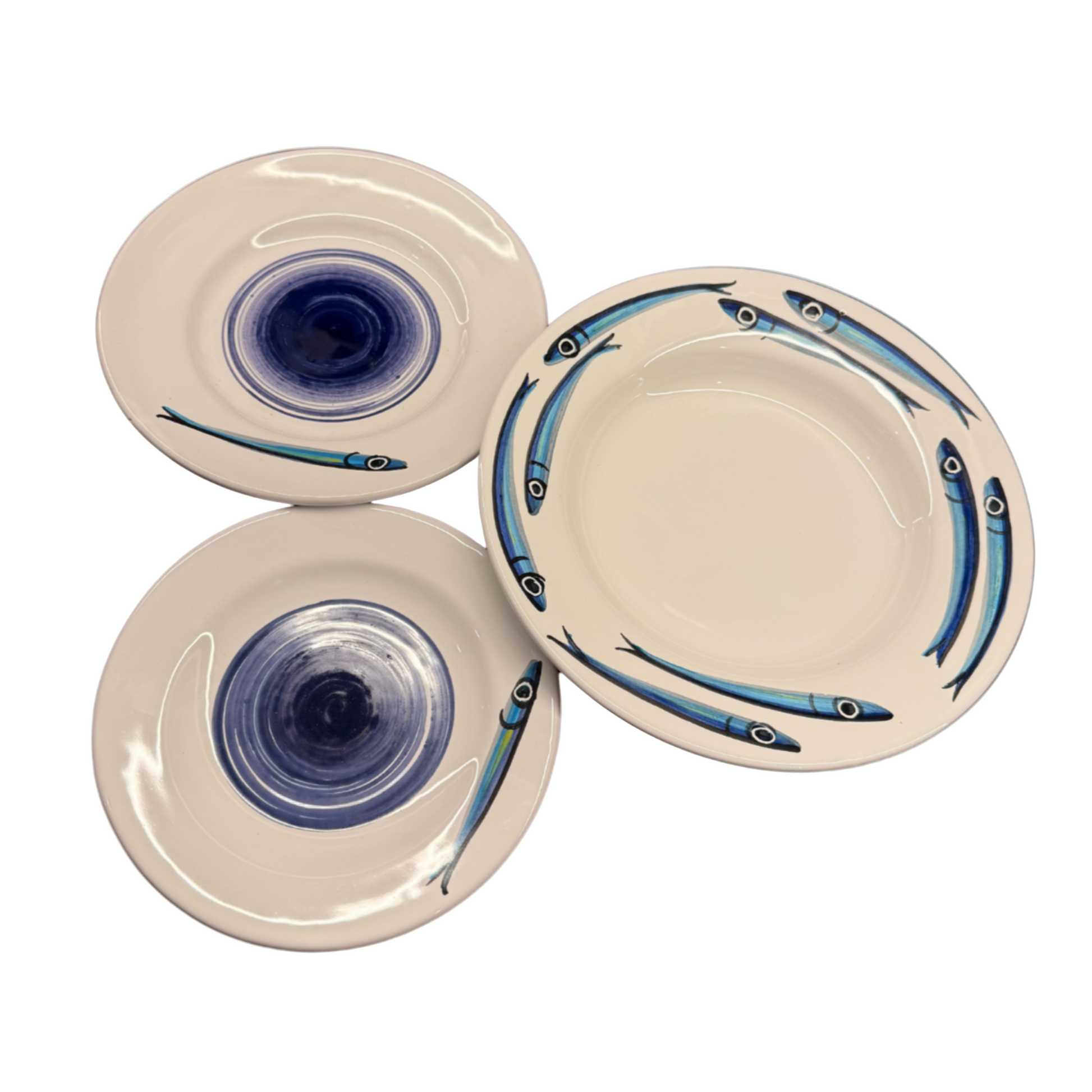 Set of ceramic plates with fish design on a white background