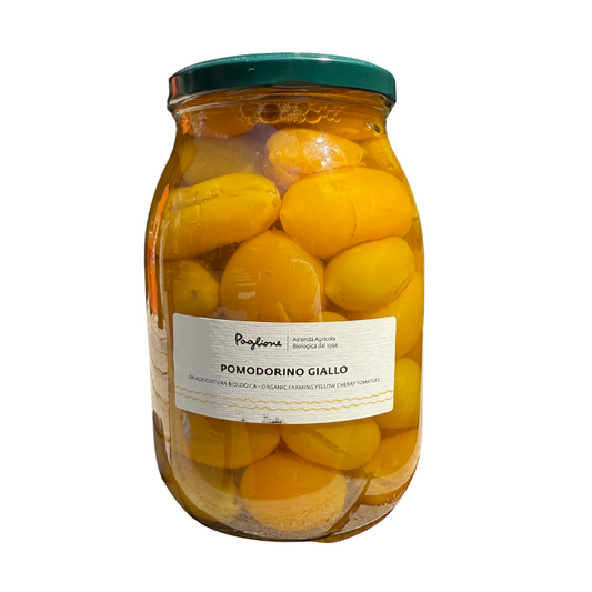 Jar of yellow tomatoes with a label on a white background